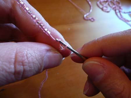 Chain stitches with the beads.